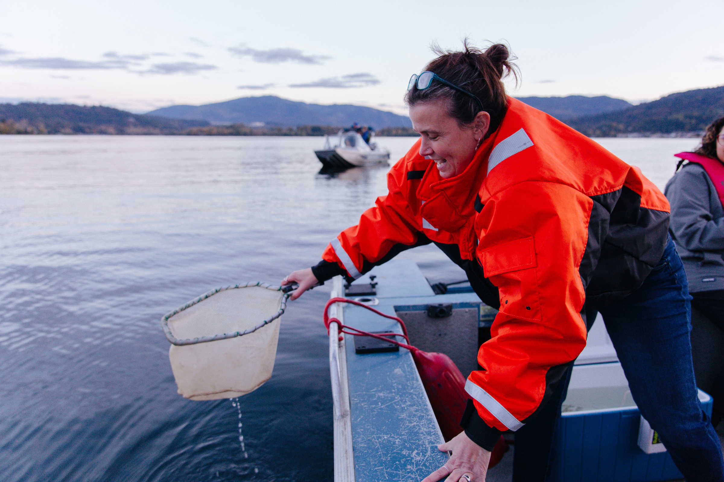 Woman releasing Kokanee salmon into the wild