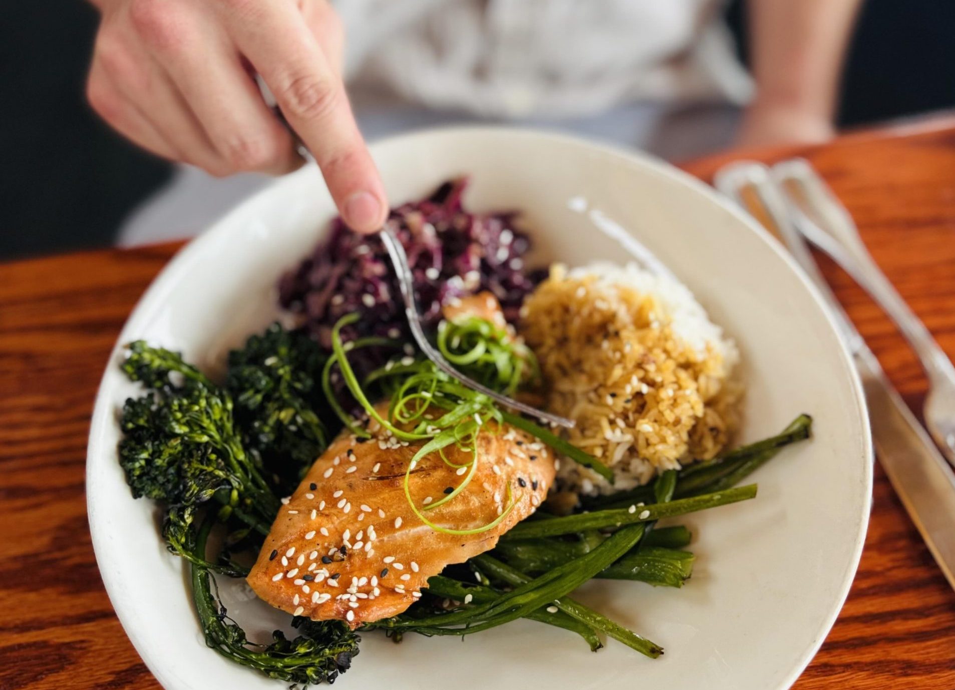 Man eating a salmon teriyaki salmon bowl at Ray's Cafe in Seattle.